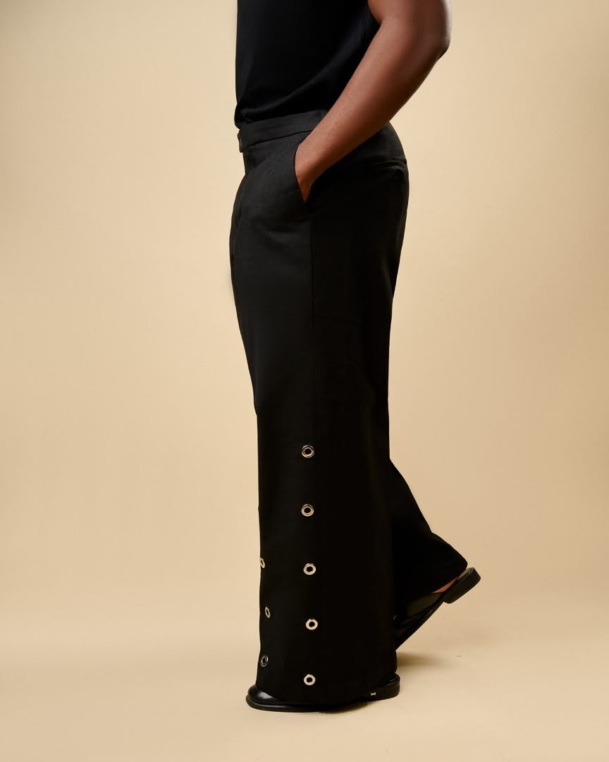 Eyelet hem detail on the black column trouser